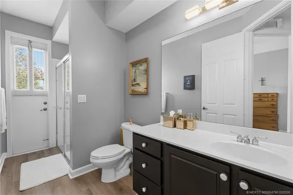 a bathroom with a granite countertop sink toilet a large mirror and shower