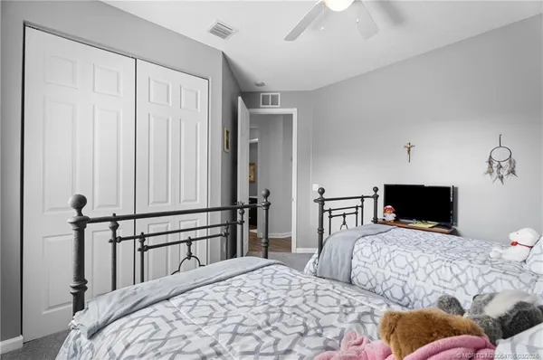 a bedroom with a large bed and a tv