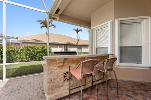 a view of a patio with table and chairs and potted plants