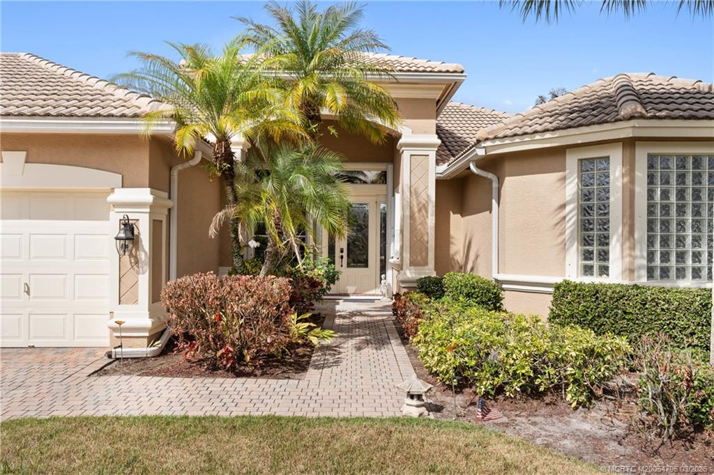 758 Southwest Blue Stem Way Stuart, FL 34997 - Photo 4 of 49 a front view of a house with a yard