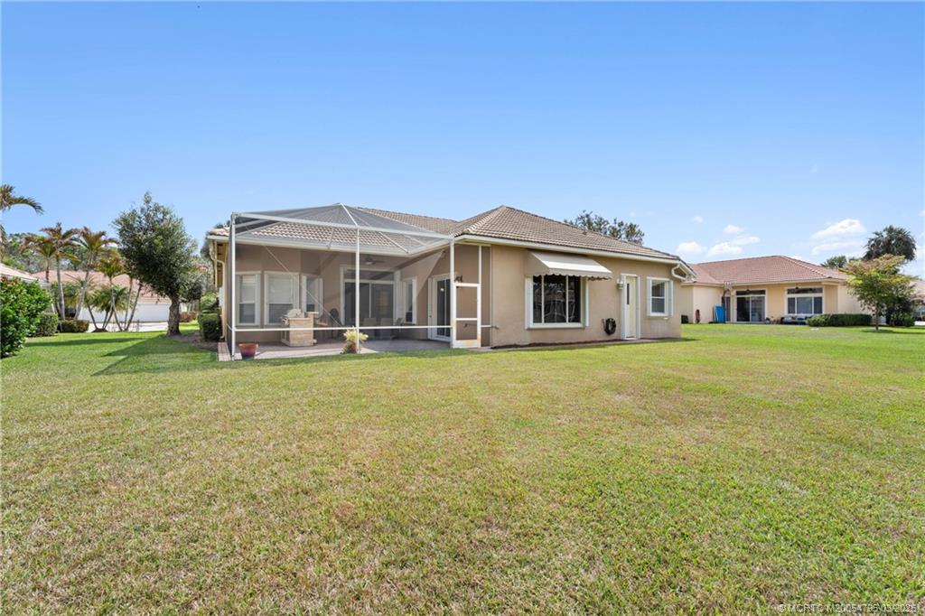 758 Southwest Blue Stem Way Stuart, FL 34997 - Photo 42 of 49 a front view of a house with garden