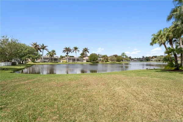 a view of a lake with houses in the back