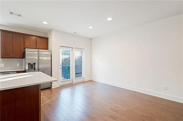 a view of a kitchen with a sink and a refrigerator