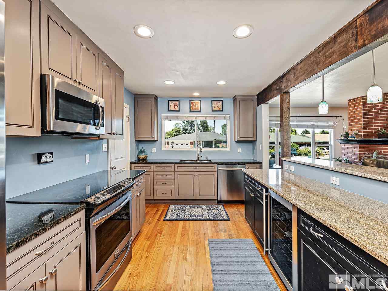 1530 California Avenue Reno, NV 89509 - Photo 5 of 21 a large kitchen with stainless steel appliances granite countertop a stove a sink and a microwave