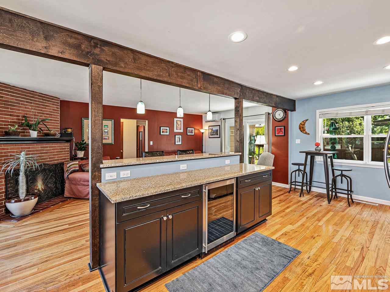 1530 California Avenue Reno, NV 89509 - Photo 6 of 21 a kitchen with stainless steel appliances granite countertop wooden floors and large window