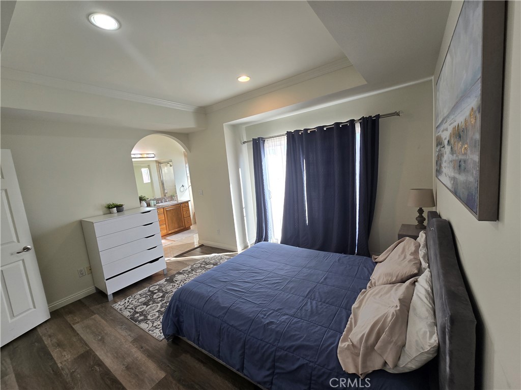 8026 Telegraph Road Downey, CA 90240 - Photo 15 of 26 a bedroom with a bed and wooden floor