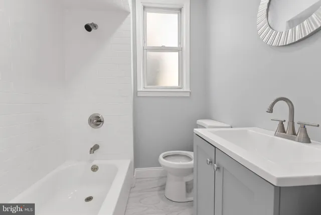 a bathroom with a sink a toilet and bathtub