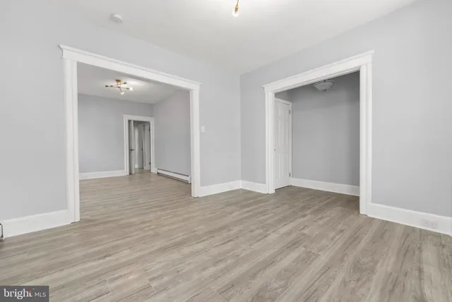 an empty room with wooden floor and closet