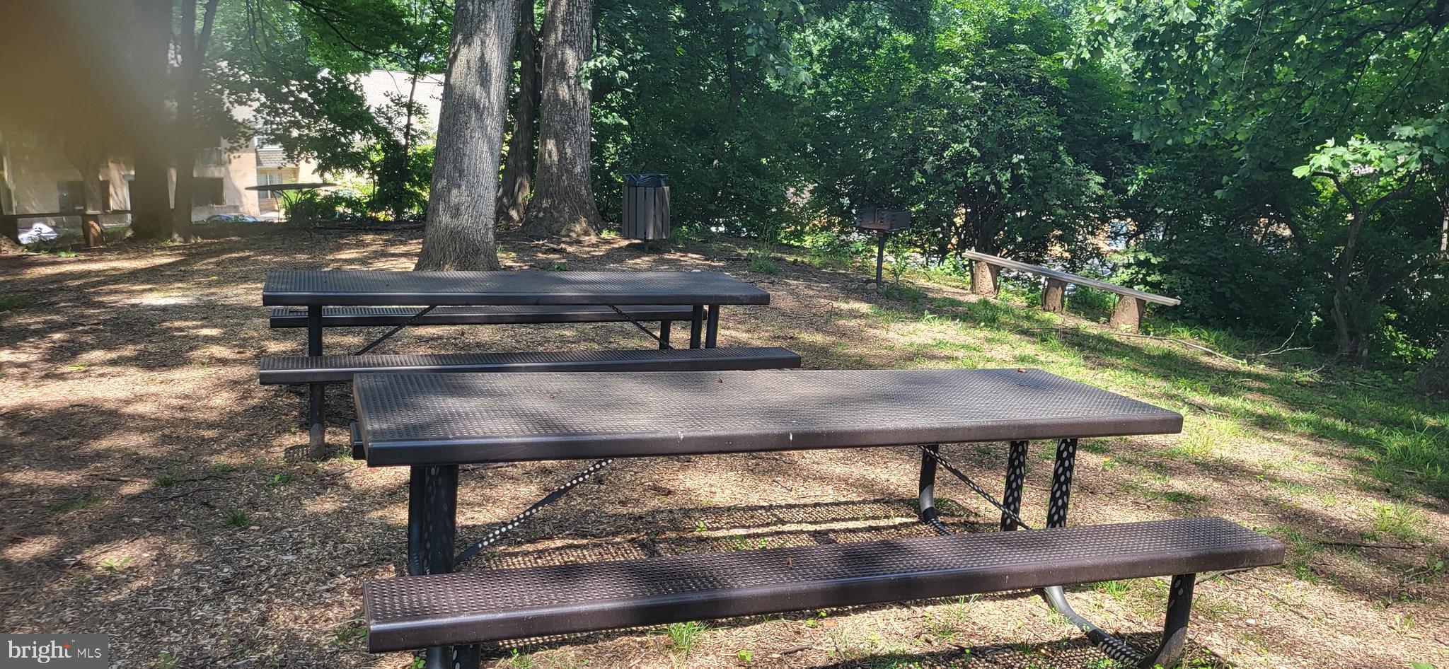 5800 Cove Landing Road, Unit 303 Burke, VA 22015 - Photo 74 of 84 a view of a wooden chairs and fire pit in the backyard