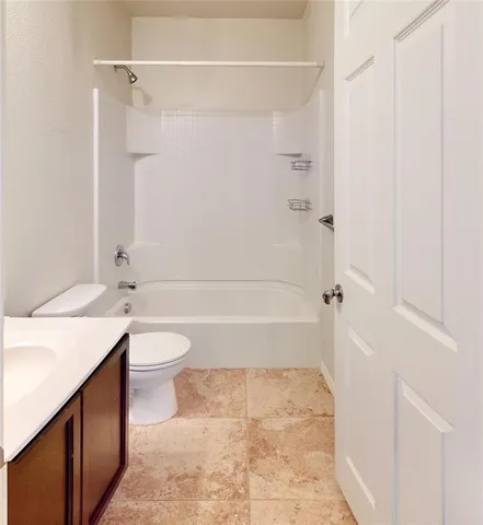 a bathroom with a toilet and a bathtub