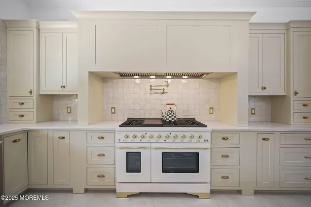 a living room with lots of furniture and a chandelier