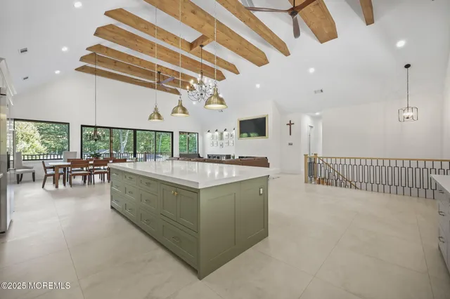 a view of a dining room with furniture and a chandelier