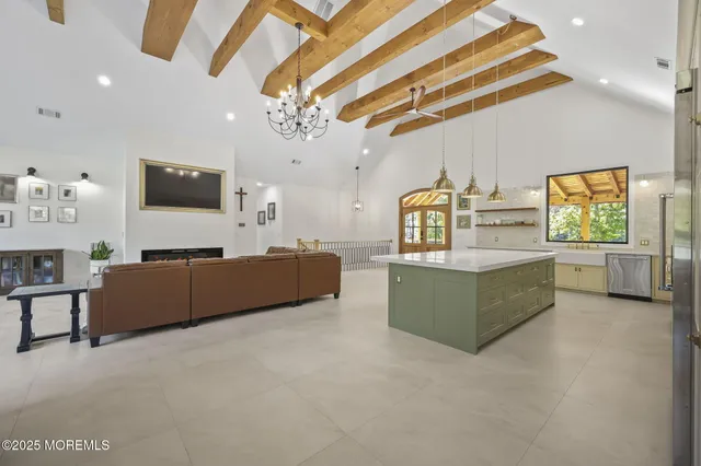 a bedroom with furniture and a large window