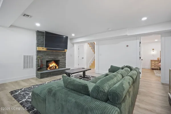 a large kitchen with stainless steel appliances wooden cabinets a stove and a sink