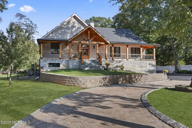a front view of a house with garden and sitting area