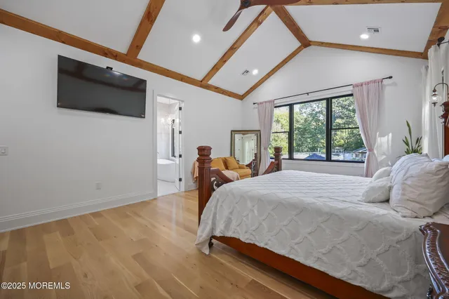 a bed sitting in a bedroom next to a window