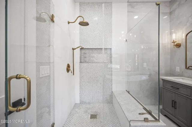 a bathroom with a granite countertop sink a toilet and shower