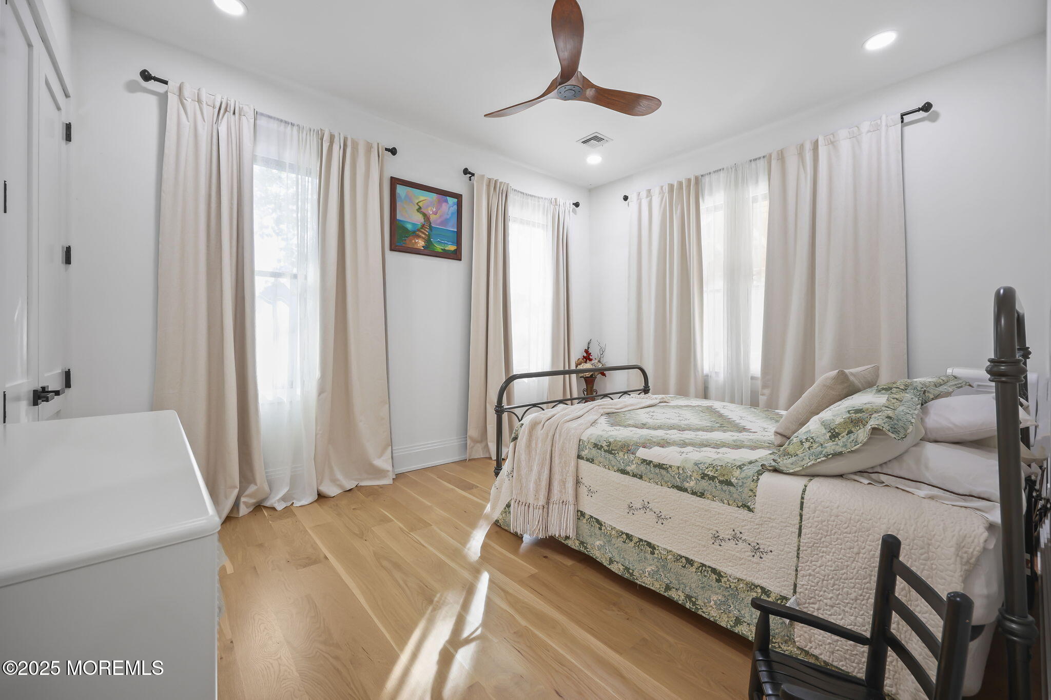 422 Green Grove Road Asbury Park, NJ 07712 - Photo 40 of 82 a bed room with a bed and a chandelier