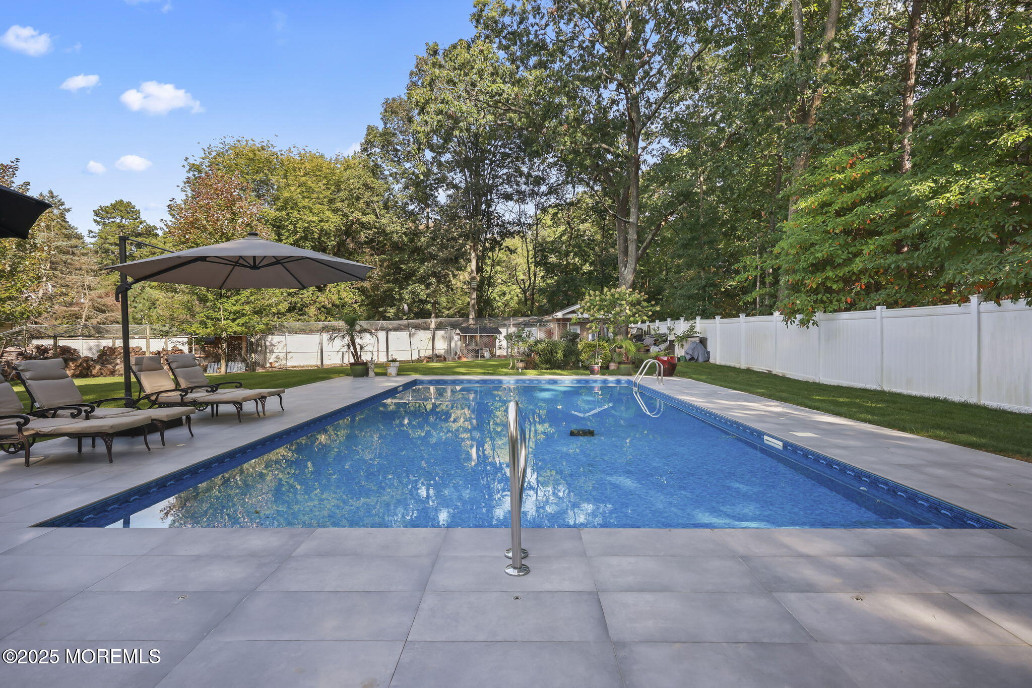 422 Green Grove Road Asbury Park, NJ 07712 - Photo 65 of 82 a view of a swimming pool with a lounge chair