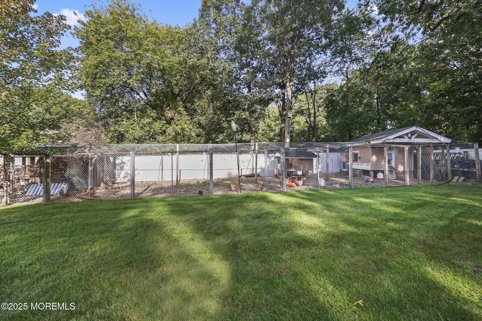 422 Green Grove Road Asbury Park, NJ 07712 - Photo 69 of 82 a view of a house with a yard table and chairs