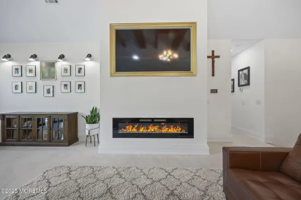 a bedroom with furniture and a large window