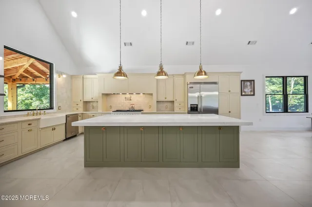a kitchen with granite countertop white cabinets and white stove