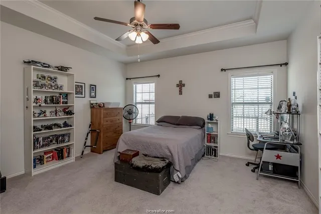 a bedroom with furniture and a chandelier