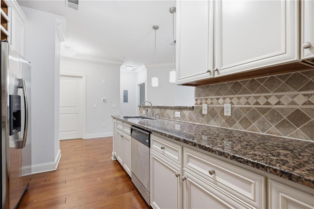 901 Abernathy Road Northeast, Unit 3080 Atlanta, GA 30328 - Photo 8 of 21 a kitchen with granite countertop a sink and a refrigerator