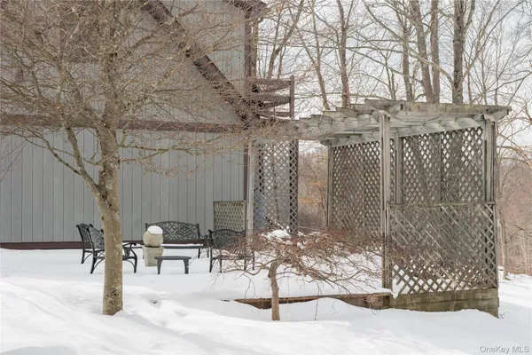 a view of a house with backyard and sitting area