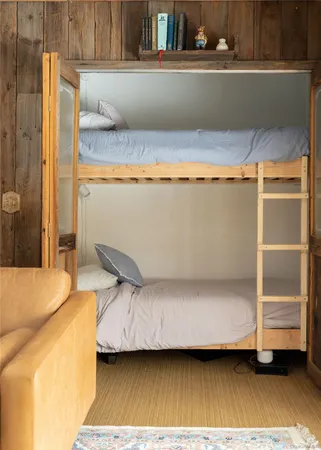 a view of a bed room with wooden floor