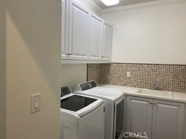 a view of storage and utility room with washer and dryer