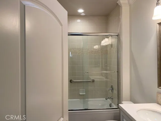 a bathroom with a shower a toilet and sink