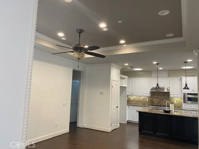 a view of kitchen with refrigerator sink and cabinets