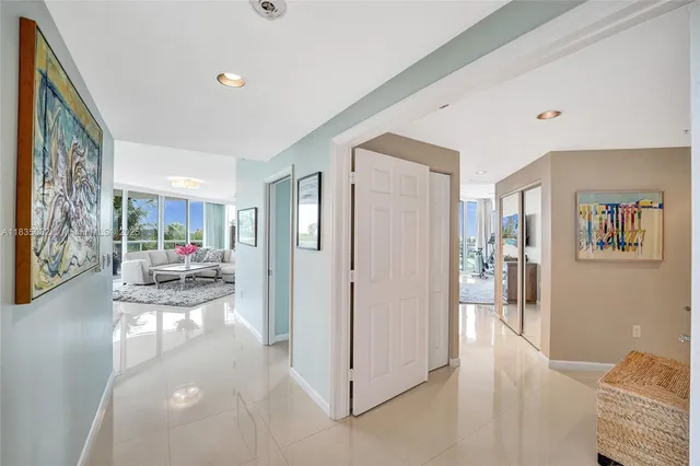 a bedroom with a bed couch and a large window