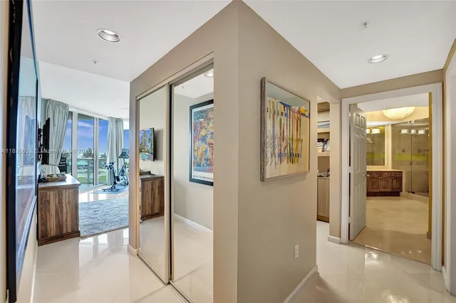 a spacious bathroom with a granite countertop double vanity sink a mirror and a bathtub