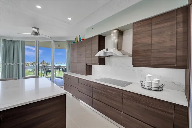 a kitchen with a sink a counter space appliances and cabinets