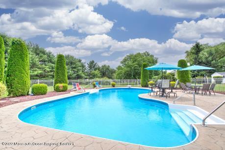 335 Buckalew Road Freehold, NJ 07728 - Photo 12 of 38 a view of a swimming pool with sitting area