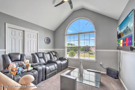 335 Buckalew Road Freehold, NJ 07728 - Photo 22 of 38 a living room with furniture and a flat screen tv