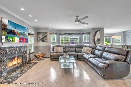 335 Buckalew Road Freehold, NJ 07728 - Photo 23 of 38 a living room with furniture and a fireplace