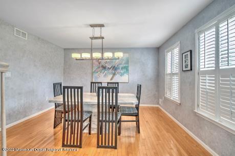 335 Buckalew Road Freehold, NJ 07728 - Photo 3 of 38 a view of a dining room with furniture wooden floor and chandelier