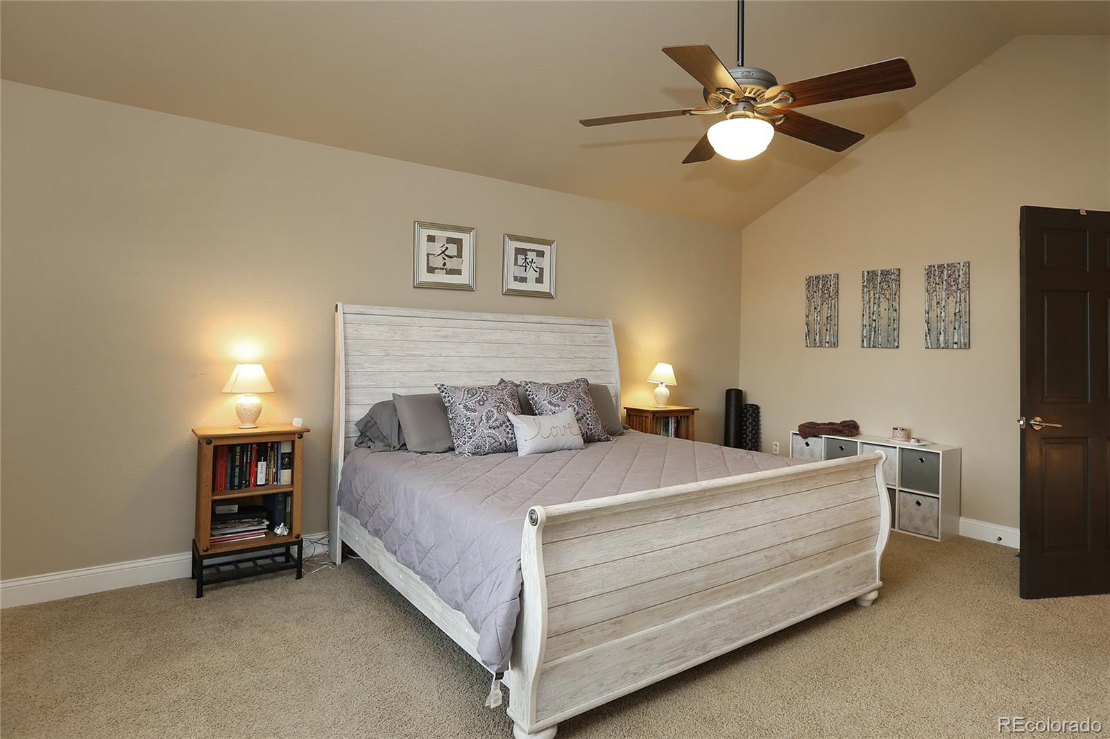 9764 Spring Hill Street Highlands Ranch, CO 80129 - Photo 17 of 32 a bedroom with a bed and a chandelier