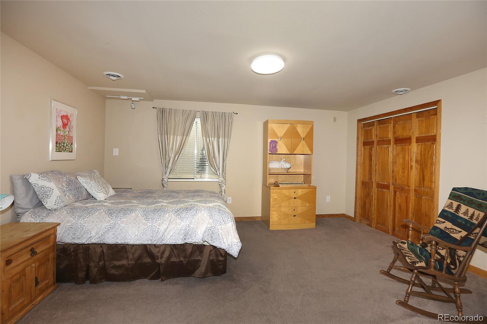9764 Spring Hill Street Highlands Ranch, CO 80129 - Photo 25 of 32 a bedroom with a bed and a closet