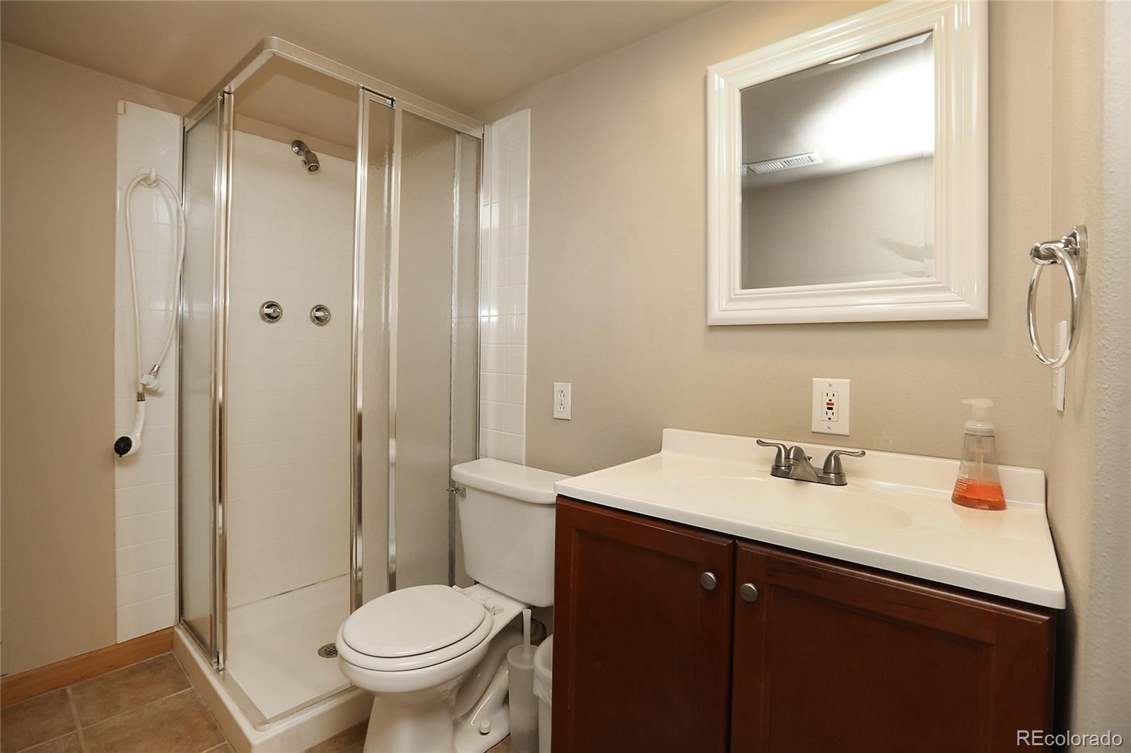 9764 Spring Hill Street Highlands Ranch, CO 80129 - Photo 27 of 32 a bathroom with a sink toilet and vanity