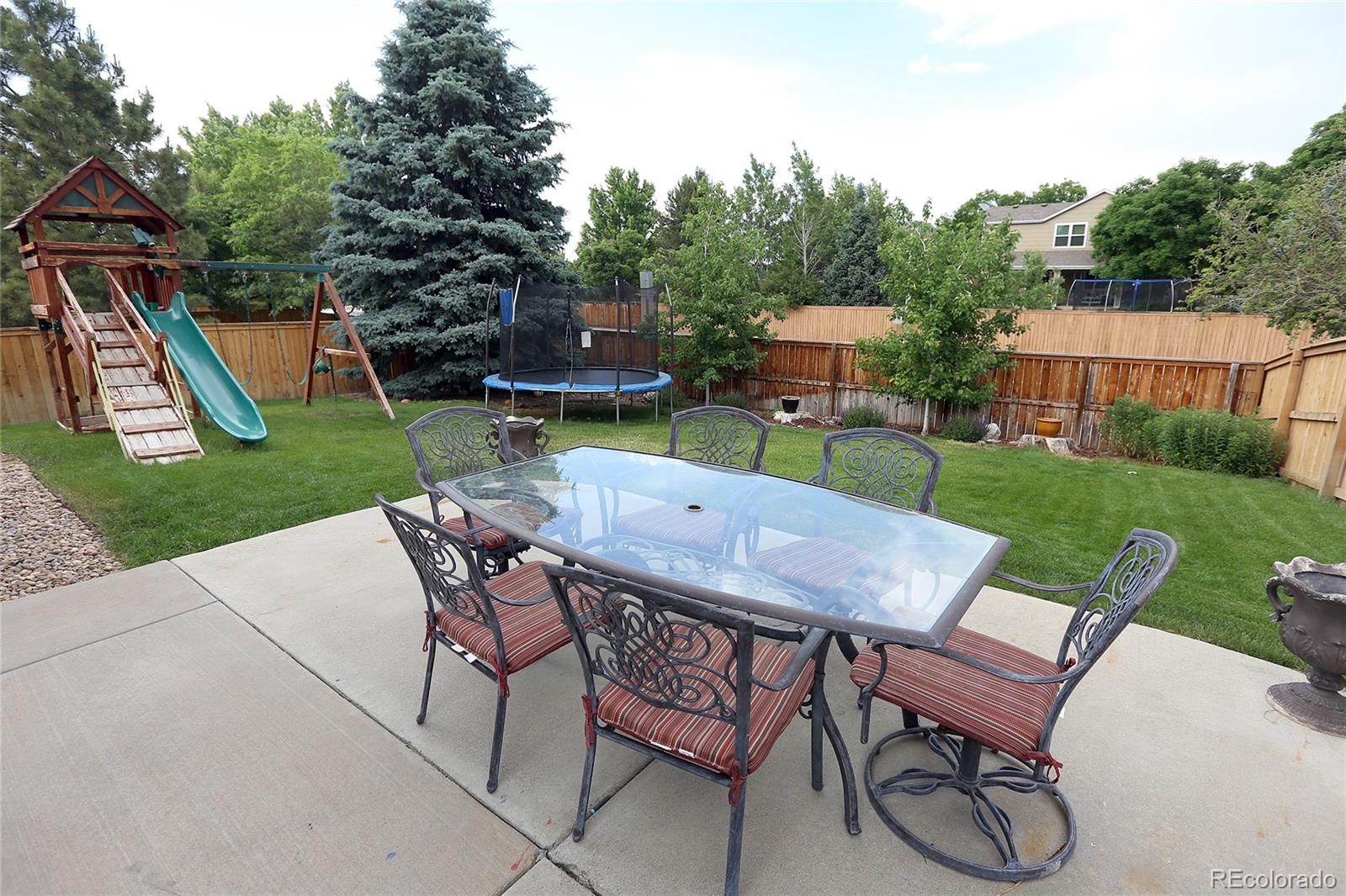 9764 Spring Hill Street Highlands Ranch, CO 80129 - Photo 30 of 32 a view of a table and chairs in backyard of the house