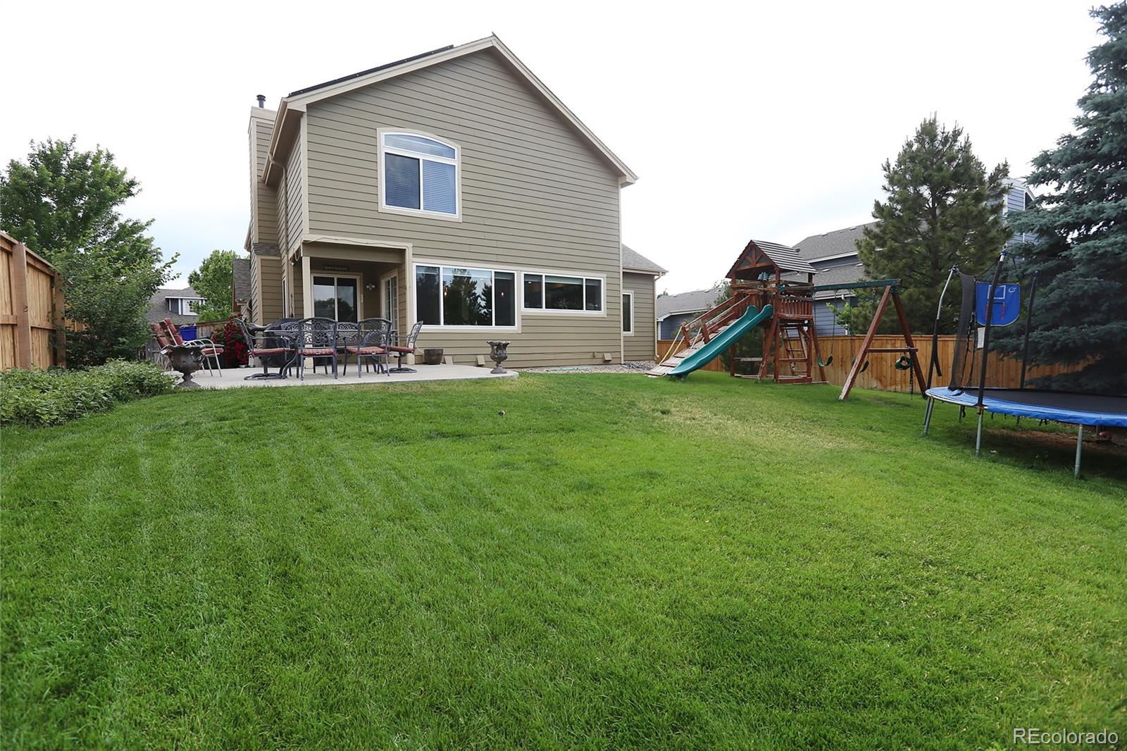 9764 Spring Hill Street Highlands Ranch, CO 80129 - Photo 31 of 32 a view of a house with backyard porch and sitting area
