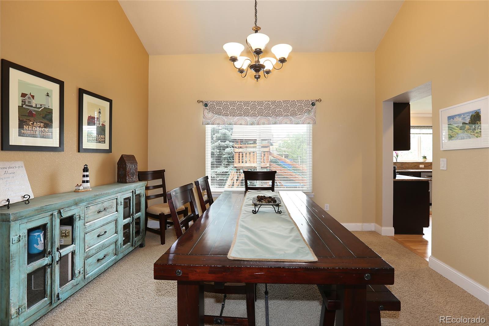 9764 Spring Hill Street Highlands Ranch, CO 80129 - Photo 7 of 32 a view of a dining room with furniture and a chandelier