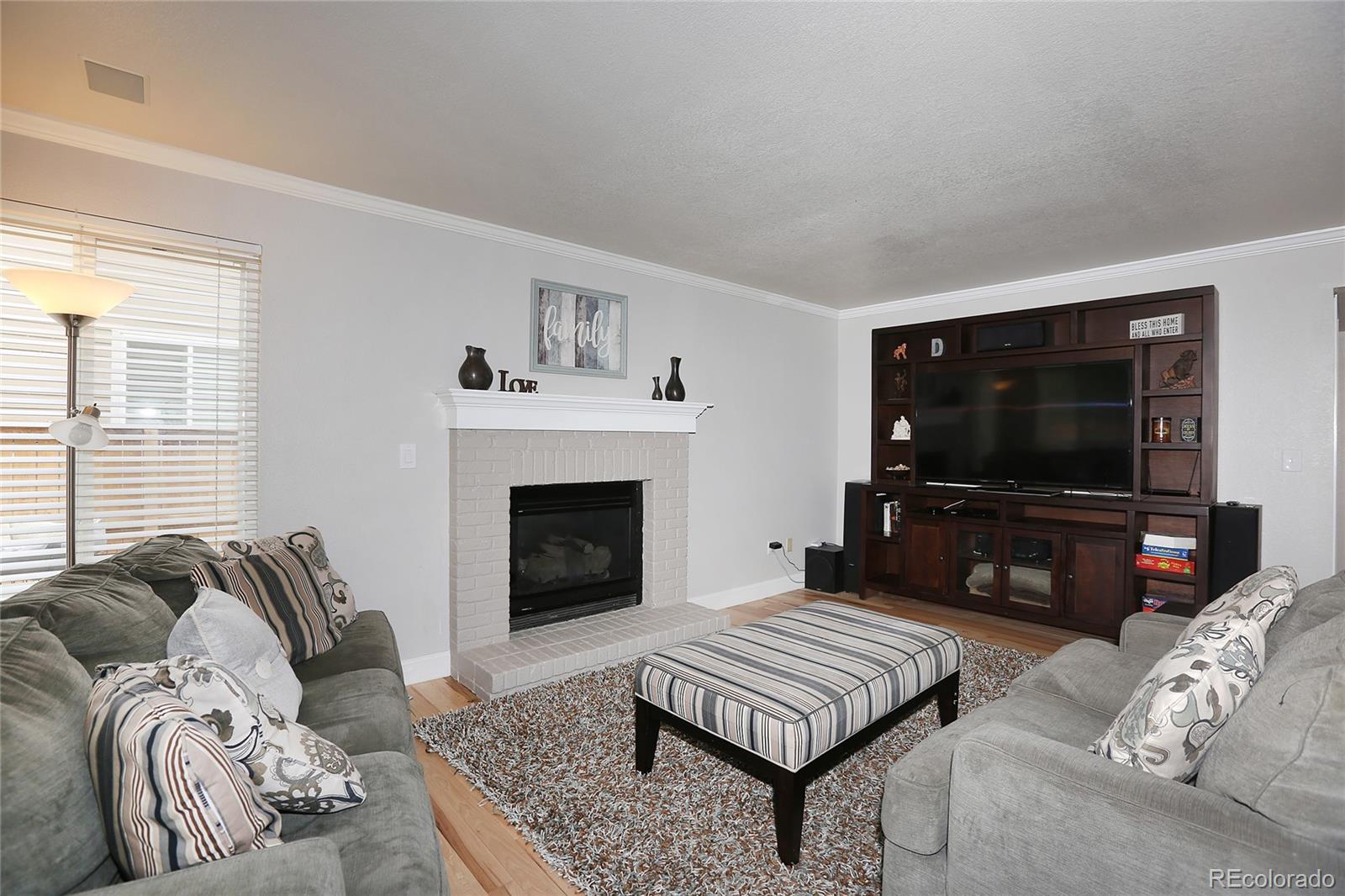 9764 Spring Hill Street Highlands Ranch, CO 80129 - Photo 9 of 32 a living room with furniture and a flat screen tv