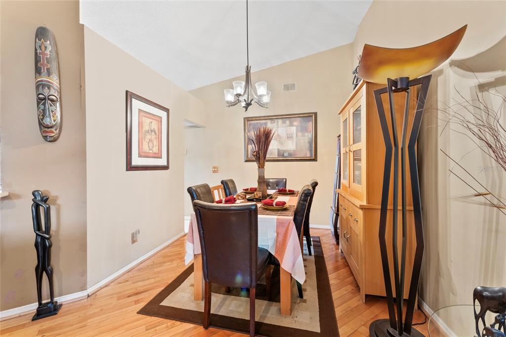9083 Sable Ridge Court Jacksonville, FL 32244 - Photo 15 of 38 a view of a dining room with furniture and a chandelier