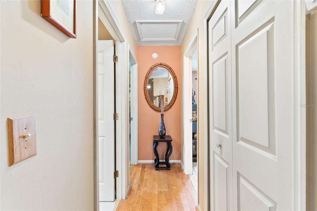 9083 Sable Ridge Court Jacksonville, FL 32244 - Photo 16 of 38 a view of a hallway with wooden floor and a bathroom