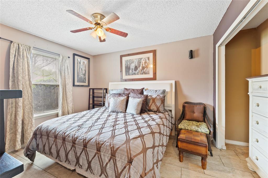 9083 Sable Ridge Court Jacksonville, FL 32244 - Photo 18 of 38 a bedroom with a bed and a couch